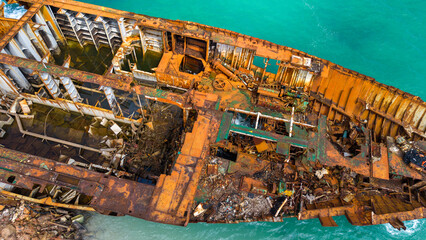 Aerial View of Rusted Shipwreck in Turquoise Waters
