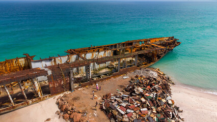 Aerial View of Rusted Shipwreck on Sandy Beach
