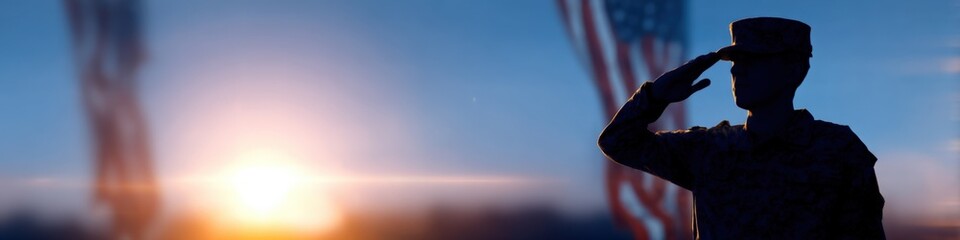 Silhouette of a saluting male soldier at sunset with american flag background