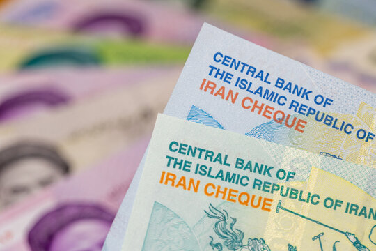 Iranian currency. Economic concept, financial situation. New toman banknotes and older rials. Business background. Close up
