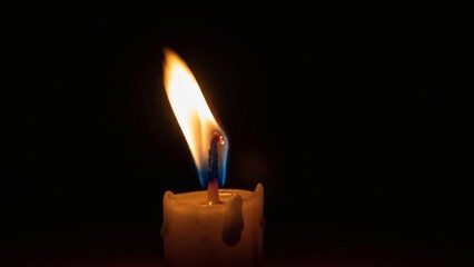 Candle Flame Burning in Dark Space.