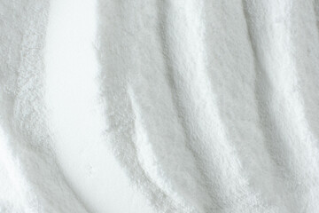Soda powder sodium bicarbonate surface. Abstract white background. White texture with wavy patterns...