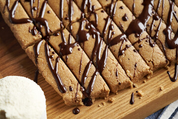 Close up of homemade snack bars made of whey protein powder, ground oat flakes, maple syrup and nut butter