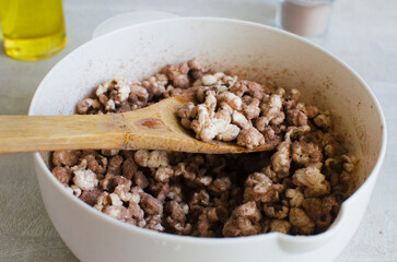 Protein popcorn in a white bowl on a light table