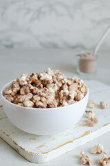 Protein Popcorn in a White Bowl on a Light Background