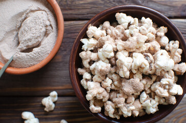 Protein popcorn in a bowl on a wooden background