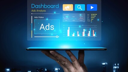 Hand holding tablet displaying futuristic dashboard with ads analysis, charts, graphs, and digital interface elements in modern business environment Gluon.