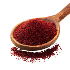 Ground sumac spice pile in wooden spoon isolated
