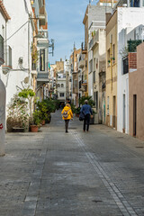 Couple walking through the historic center of Badalona Spain