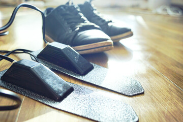 Electric shoe dryer insoles against a blurred casual sneaker background. Represents health anxiety-driven purchases, invisible bacteria concerns, urban wellness equipment, and odor control priority.