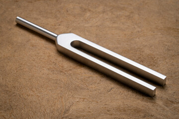 Metal tuning fork used for tuning musical instruments, sound therapy or relaxation.