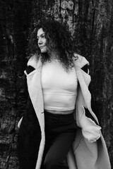 Fototapeta premium Woman with curly hair. Black and white portrait. Winter nature