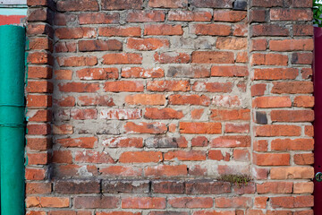 Red old brick wall background, brick wall texture. Brick old, destroyed red wall, background with texture of old red brick wall and plaster elements