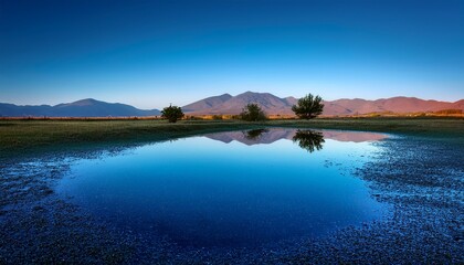 elegant landscape with discrete water puddles reflecting a vibrant spectrum of blue tones