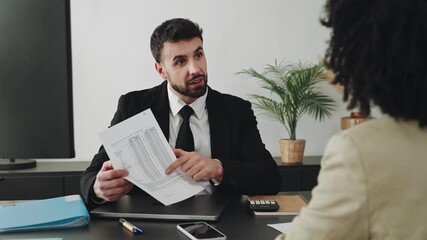 Businessman explaining financial report and doing agreement handshake between professionals after successful business meeting at the office - Powered by Adobe