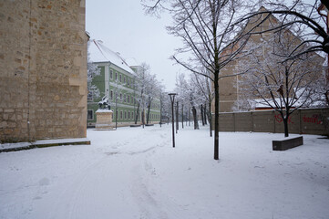 Cluj-Napoca/Romania. 1/07/2026: Snow covered city square with historic buildings during winter snowfall