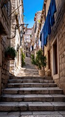 Obraz premium Narrow Cobblestone Stairs in Historic Mediterranean Old Town