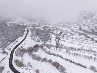 Odemis valley village and fields under winter snow