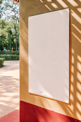 Blank White Poster on Warm Wall with Sunlight Shadows, Minimalist Graphic Resource for Design, Branding, or Advertising