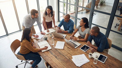 Collaborative Dynamics: A dynamic team of professionals engages in a brainstorming session around a rustic wooden table.