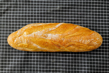 Freshly baked bread on a checkered cloth