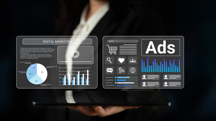 Professional holding tablet displaying digital marketing analytics with graphs and advertising insights, emphasizing data-driven decision making in modern business. Gantry