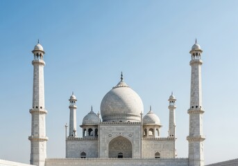 Fototapeta premium Majestic white marble structure featuring intricate details, grand central dome, and towering minarets against a clear blue sky, cultural, detailed, symmetrical