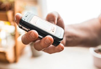 Fototapeta premium Man holding a feature phone for digital detox.
