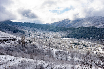 Bozdag village nestled in snowy mountain valley landscape.