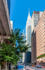 Naklejka premium Skyscrapers in Midtown Manhattan under a blue sky