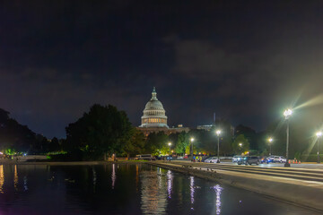 World famous United States Capitol Building reflected on the pool at night