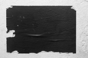 old black torn poster on the wall