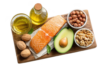 wooden board with healthy food, a salmon fillet and avocado on it