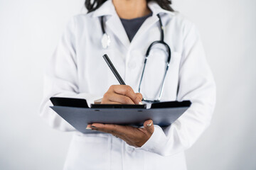Close-up of doctor writing patient report on clipboard