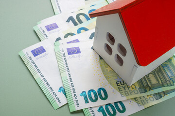 House model on euro banknotes. Real estate investment and mortgage.