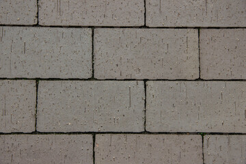 Obraz premium Textured gray paving stones arranged in a neat pattern, showcasing the durability and design of outdoor surfaces, ideal for landscaping and construction projects