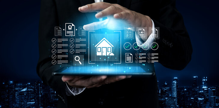 A businessman showcases a tablet displaying holographic icons related to real estate, emphasizing the fusion of technology and property management in a modern urban setting. Gantry - Powered by Adobe