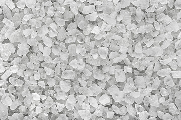 Crystal of organic sea salt as background, top view. White marine rock salt.
