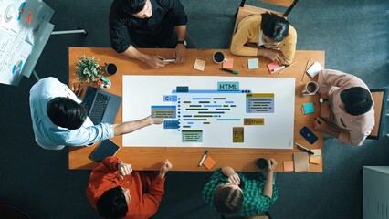 Dynamic meeting scene featuring diverse professionals discussing programming languages and strategies at a modern conference table, fostering teamwork and creativity. Raster