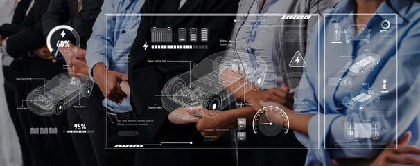 A group of business professionals engages in a discussion about electric vehicle technology, featuring interactive digital displays of data and innovative statistics. Trope