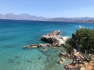 Turquoise Mediterranean sea with rocky coastline and clear water