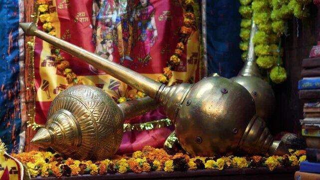Golden Hanuman Gada Close-Up with Temple Decorations and Devotion
