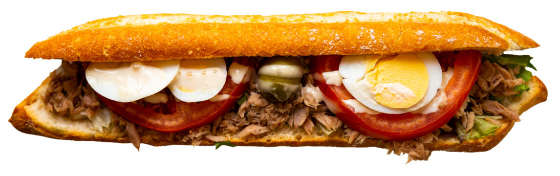Spanish sandwich with tuna, egg and vegetables on fresh bread. Traditional baguette bocadillo con atun on a white plate side view. Isolated over white background