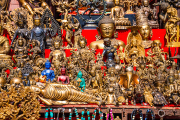 Souvenir shop counter with many small bronze sculptures.