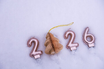 Winter New Year 2026 scene on snow with a paper Christmas tree ornament used as zero.