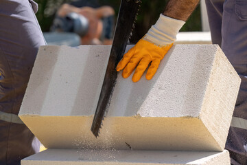 The bricklayer is working. Building a wall of aerated concrete. Gasbeton wall
