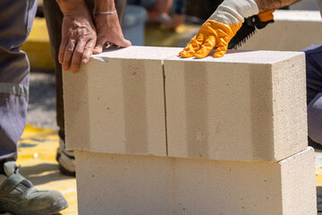 The bricklayer is working. Building a wall of aerated concrete. Gasbeton wall