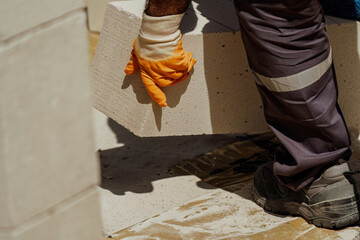 The bricklayer is working. Building a wall of aerated concrete. Gasbeton wall