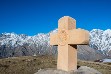 Stone cross next to Tsminda Sameba Trinity Church in Gergeti village near Stepantsminda, Georgia