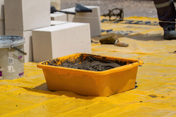 The bricklayer is working. Building a wall of aerated concrete. Gasbeton wall